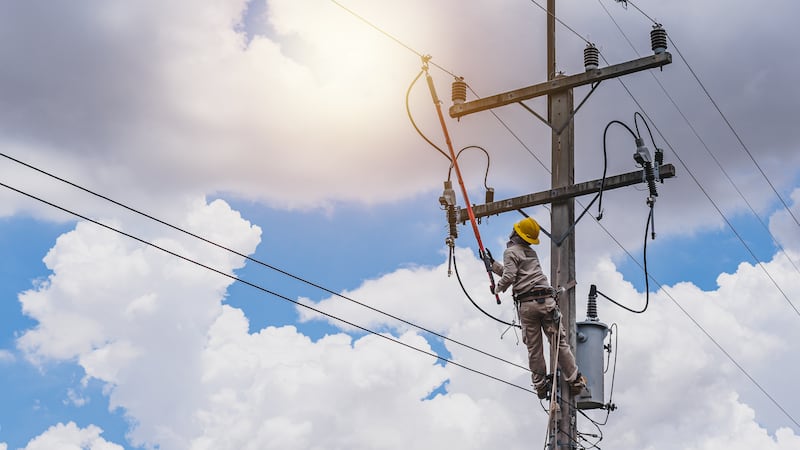 The power lineman use clamp stick (insulated tool) to closing a transformer on energized...