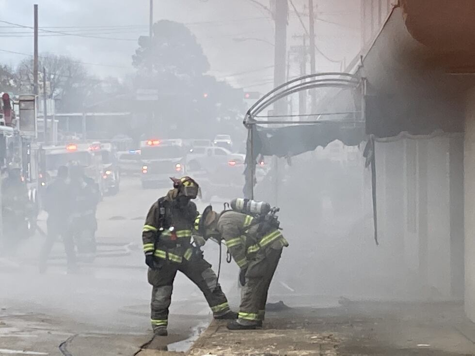 Firefighters are rescuing people from a building which appears to be on fire on East Erwin...