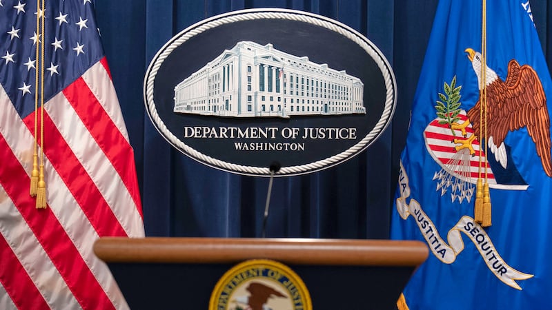 The Department of Justice seal and podium is viewed at the Department of Justice headquarters...