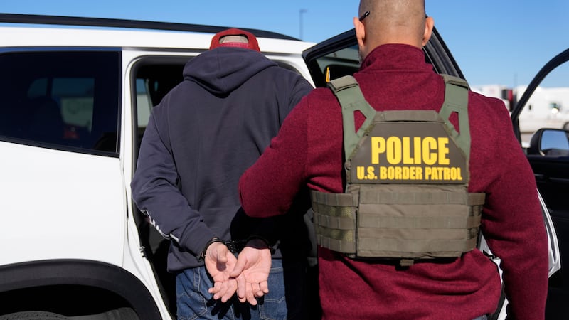 U.S. Border Patrol agents detain a truck driver during an immigration enforcement operation at...