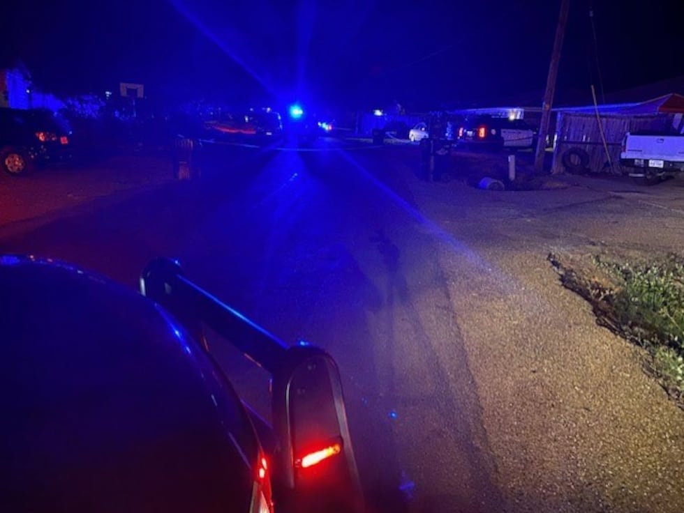 Multiple police units block off street to conduct investigation on fatal shooting.