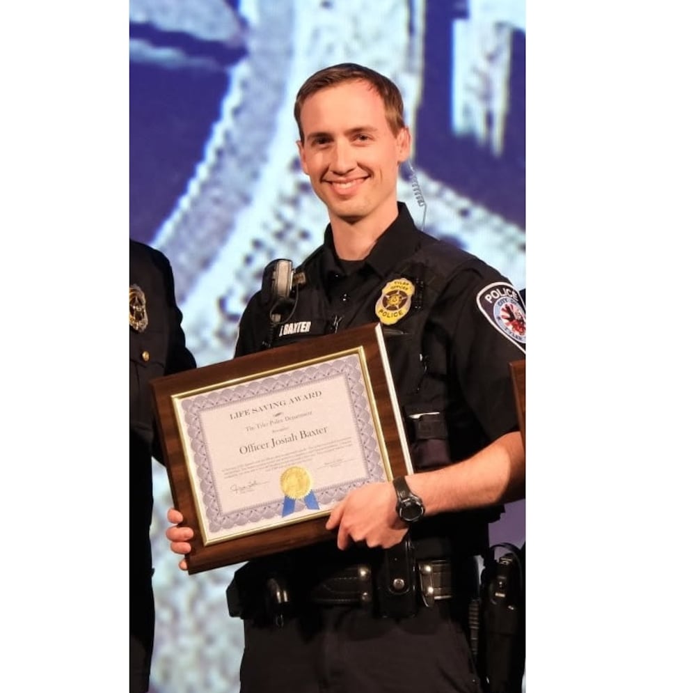 Officer Josiah Baxter, shown here in 2021 receiving life saving award.