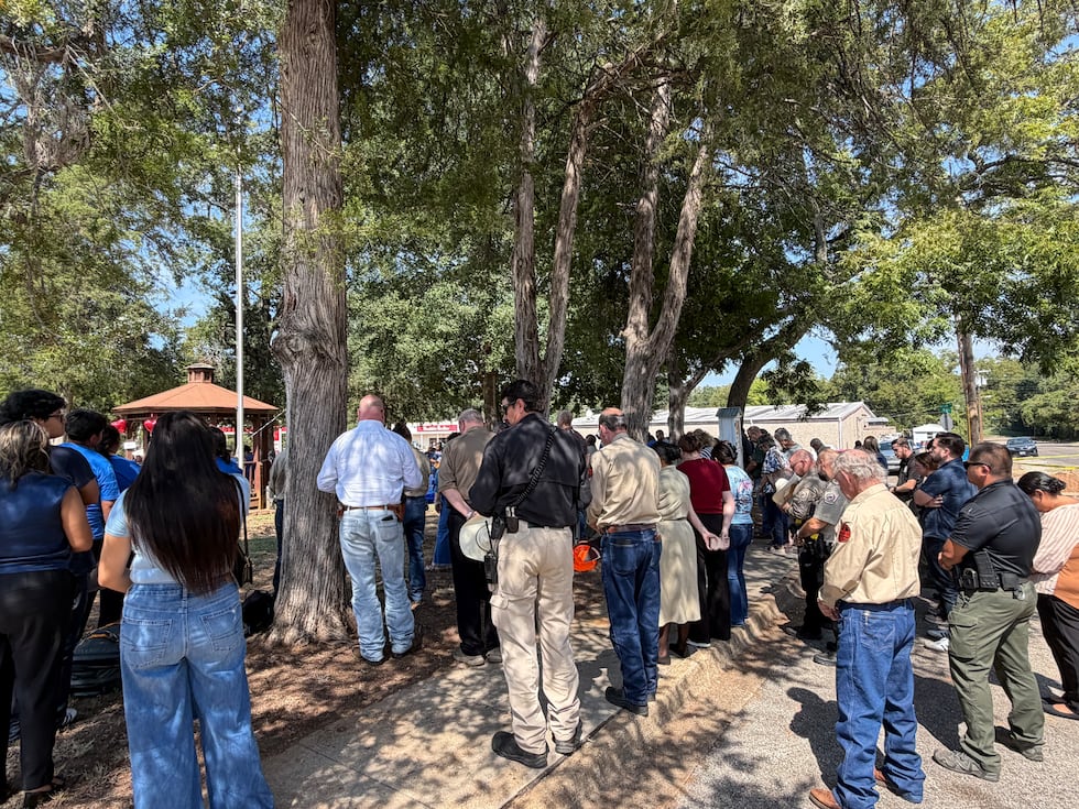 The community turned out in force for the vigil and prayed around the families of all three men.