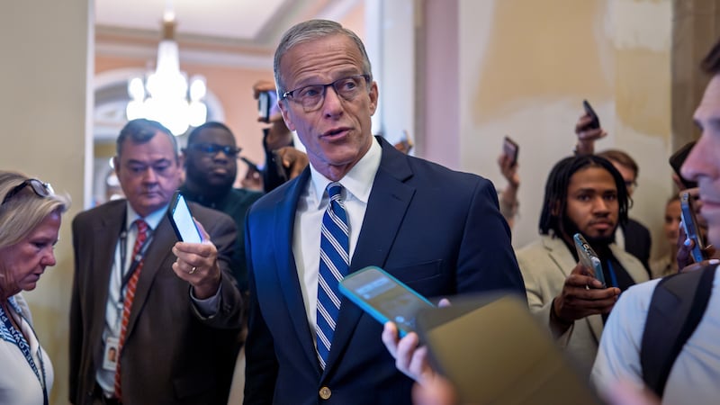 Senate Majority Leader John Thune, R-S.D., pauses for questions from reporters before votes on...